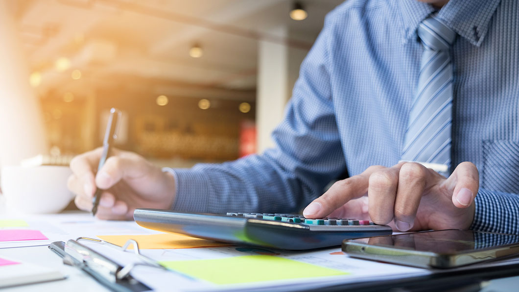 Accountant working on a calculator						
