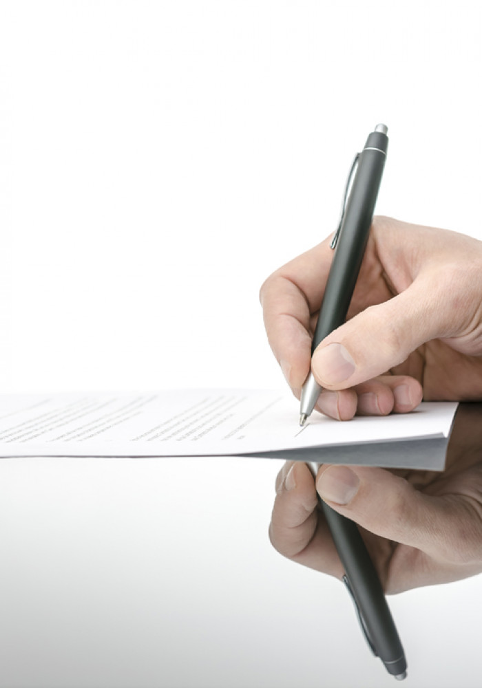 man signing a contract with a matte black pen